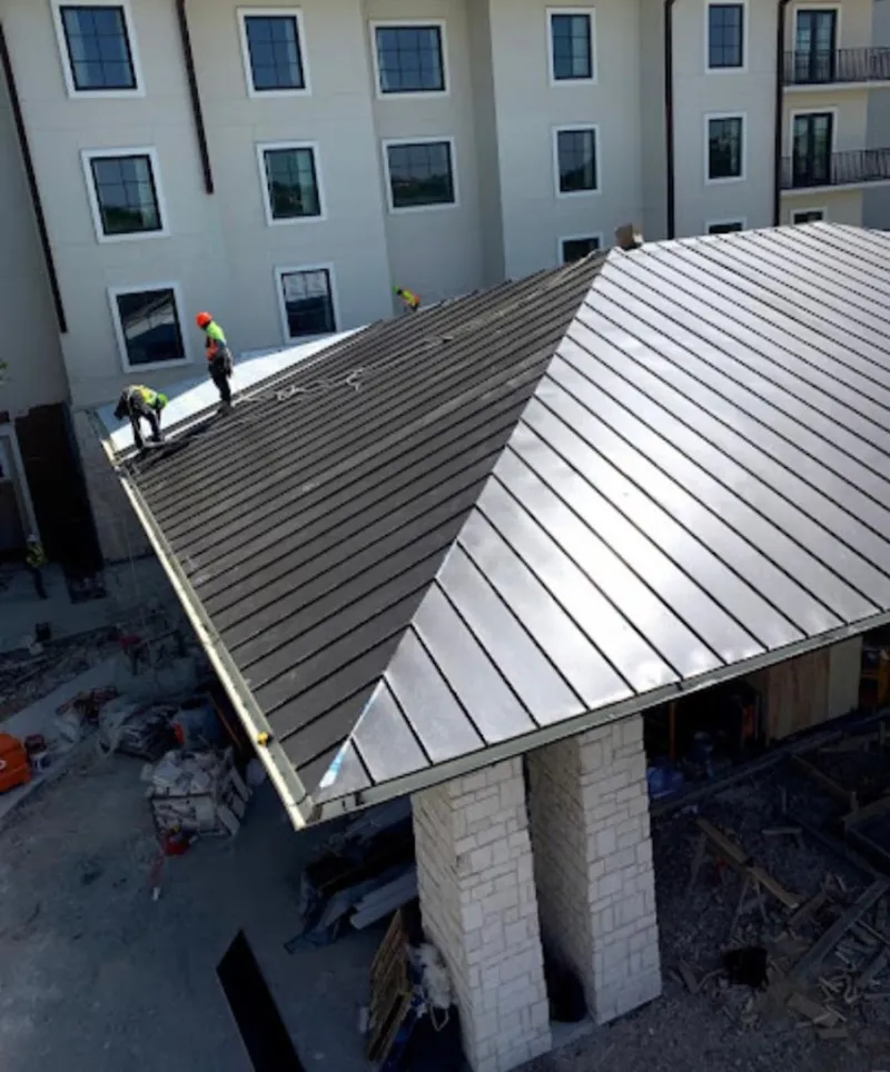 Crew installing standing seam metal roof panels on a commercial project in Schuylkill Haven
